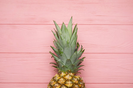 Fresh pineapple on color wooden backgroundの写真素材