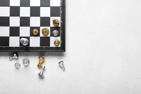 Game board with chess pieces on white backgroundの写真素材