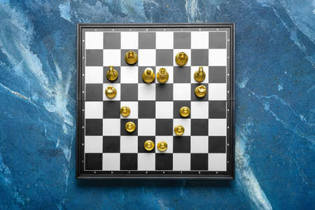 Heart made of chess pieces on color backgroundの写真素材