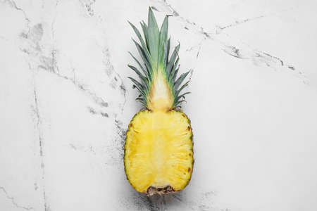 Half of fresh pineapple on white backgroundの写真素材