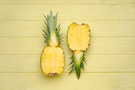 Cut fresh pineapple on color wooden backgroundの写真素材