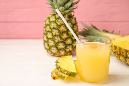 Glass of fresh pineapple juice on tableの写真素材