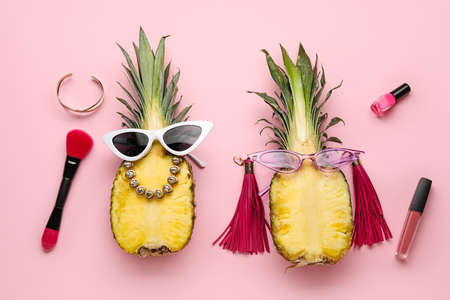 Pineapples with female accessories on color backgroundの写真素材