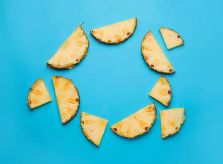 Frame made of fresh pineapple slices on color backgroundの写真素材