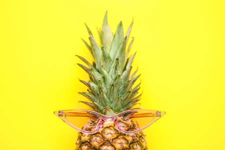 Pineapple with sunglasses on color backgroundの写真素材