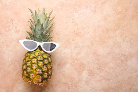 Pineapple with sunglasses on color backgroundの写真素材