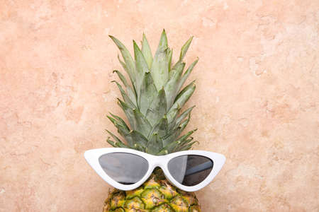 Pineapple with sunglasses on color backgroundの写真素材