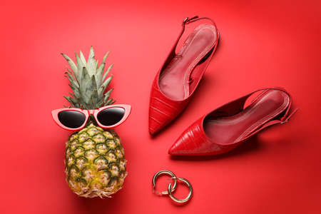 Pineapple with female accessories on color backgroundの写真素材