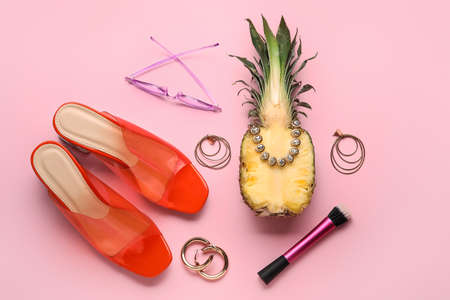 Pineapple with female accessories on color background