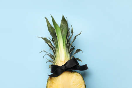 Pineapple with bow on color backgroundの写真素材