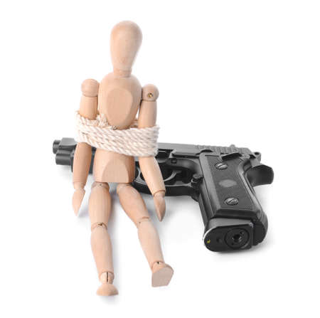 Gun and mannequin with tied around rope on white background. Concept of hostage
