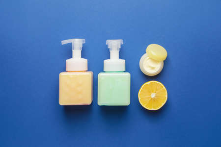 Natural cosmetic products with citrus fruit on color backgroundの写真素材