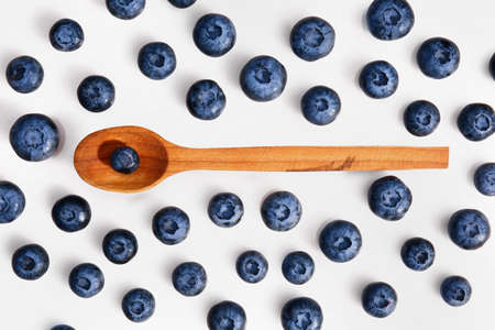 Wooden spoon with tasty ripe blueberries on white backgroundの写真素材