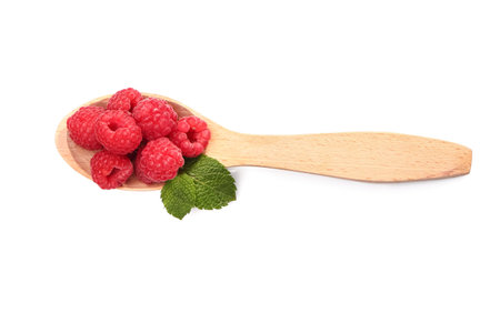 Wooden spoon with tasty ripe raspberries on white backgroundの写真素材