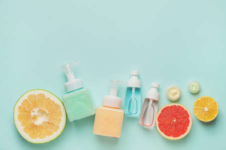 Natural cosmetic products with citrus fruits on color backgroundの写真素材