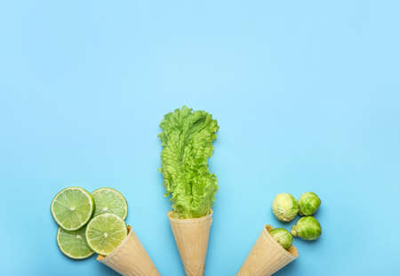 Composition with fresh vegetables and waffle cones on color backgroundの写真素材