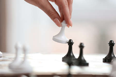 Young woman playing chess at home, closeupの写真素材