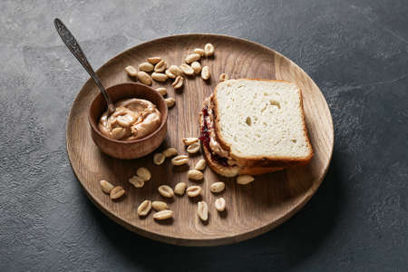 Tray with tasty peanut sandwich on dark backgroundの写真素材