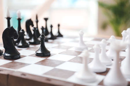 Board with chess pieces on blurred background, closeupの写真素材