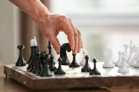 Man playing chess at home