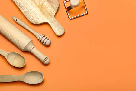Set of kitchen utensils on color background