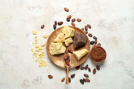Composition with cocoa butter, powder and beans on light backgroundの写真素材