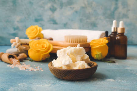 Composition with shea butter, bath supplies and flowers on color backgroundの写真素材