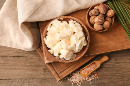 Bowl with shea butter, nuts and sea salt on wooden backgroundの写真素材