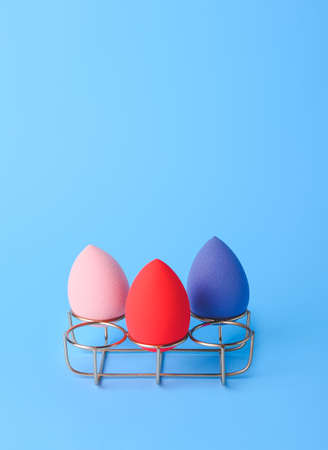 Eggs holder with makeup sponges on color backgroundの写真素材