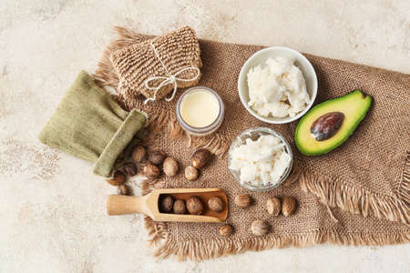 Spa set with shea butter and nuts on light backgroundの写真素材