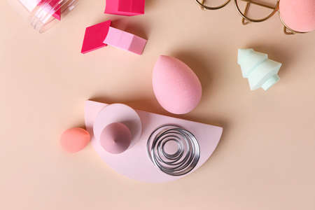 Creative composition with egg holder and makeup sponges on color backgroundの写真素材