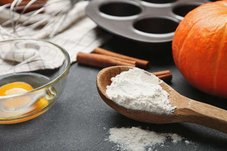 Ingredients for preparing bakery, pumpkin and utensils on dark backgroundの写真素材