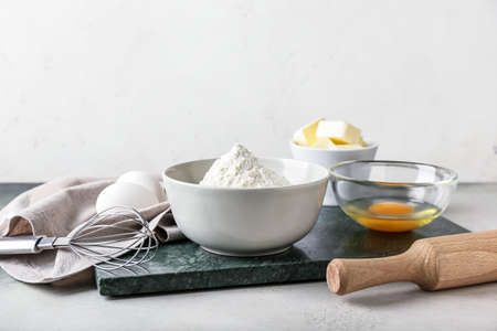 Ingredients for preparing bakery and utensils on light background