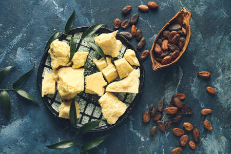 Composition with cocoa butter and beans on color backgroundの写真素材