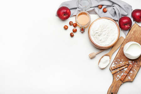 Ingredients for preparing bakery, apple and nuts on light backgroundの写真素材