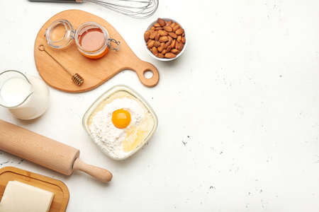 Ingredients for preparing bakery and utensils on light background