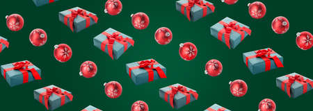 Beautiful gift boxes with Christmas balls on green backgroundの写真素材