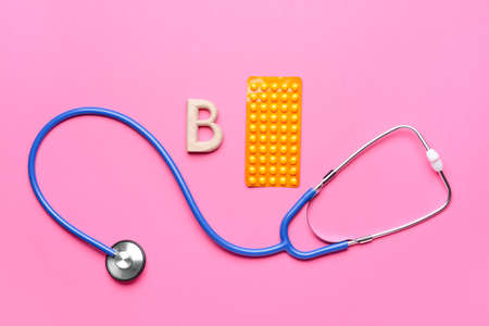 Letter B with stethoscope and pills on color backgroundの写真素材