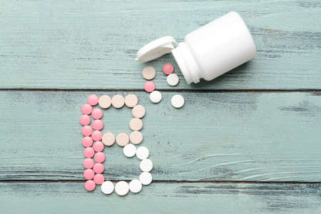 Vitamin B pills on wooden backgroundの写真素材