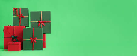 Beautiful Christmas gifts on green background with space for textの写真素材