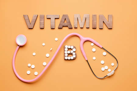 Text VITAMIN B with stethoscope and pills on color backgroundの写真素材