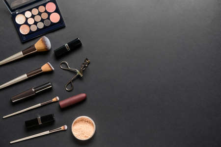 Set of professional makeup brushes with decorative cosmetics on dark backgroundの写真素材
