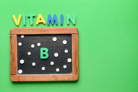 Text VITAMIN B with pills and chalkboard on color backgroundの写真素材
