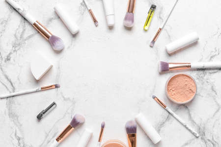 Frame made of professional makeup brushes with decorative cosmetics on white backgroundの写真素材