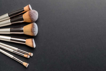 Set of professional makeup brushes on dark backgroundの写真素材