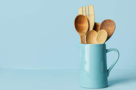 Wooden spoons and fork on color backgroundの写真素材