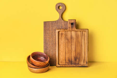 Chopping boards and bowls on color backgroundの写真素材