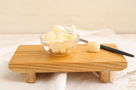 Bowl with fresh butter on light backgroundの写真素材