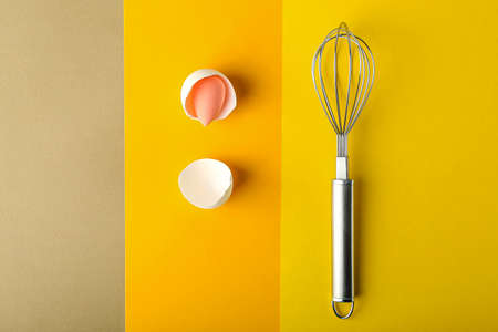 Creative composition with makeup sponge and whisk on color backgroundの写真素材