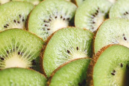 Many cut kiwi as backgroundの写真素材